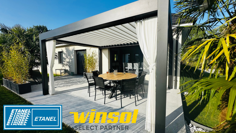 Installation pergola bioclimatique WINSOL en aluminium sur mesure avec enceintes, prises, lumières, capteurs, de couleur noire avec lames blanches, par ETANEL, à Jumièges près de Bourg‑Achard